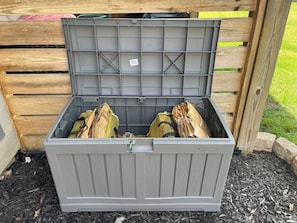 Wood provided for the fire pit. Located around the corner from the back patio.