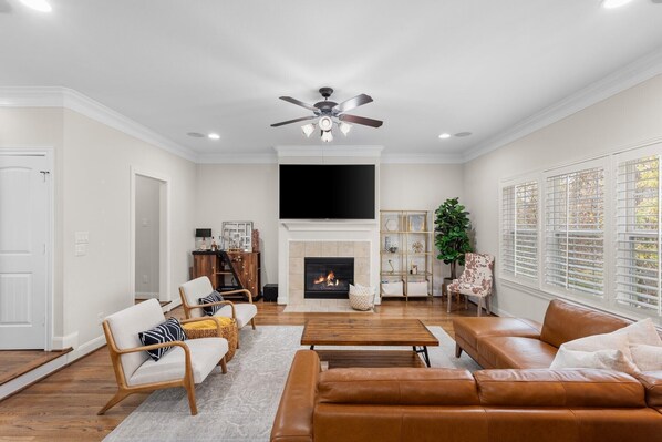 Living room with smart tv, fireplace, bar cart