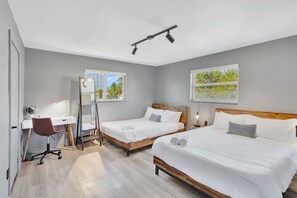 Cozy retreat with two queen-sized beds and a dedicated workspace for your comfort and productivity.
