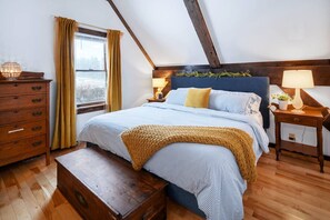 Primary bedroom features an ensuite bathroom with shower, king size Tuft & Needle mattress, high quality all-cotton bedding, and views of the sunrise. 