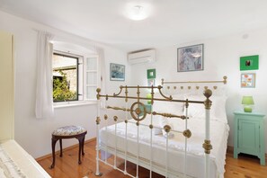 This double room with its antique brass bed is cool and comfortable.