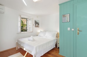 This airy double bedroom with two windows, overlooks the piazza and church