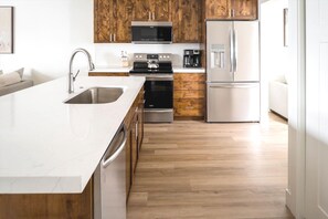 Fully Equipped Kitchen with Stainless Steel Appliances & Stone Counters