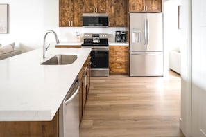 Fully Equipped Kitchen with Stainless Steel Appliances & Stone Counters