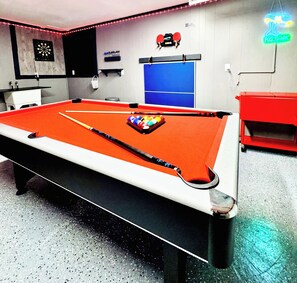 Pool Table, Darts, Ping Pong, TV, outdoor covered area for cornhole. 