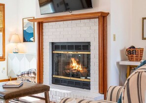 Unwind in the inviting living room, complete with a warm fireplace and a TV—perfect for spending quality time with family or friends.