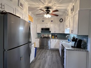 Fully equipped kitchen featuring modern appliances, plenty of counter space, and everything you need to prepare meals for your group.