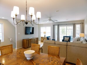 Elegant dining area with a modern chandelier, perfect for enjoying meals with family and friends.