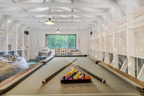 A game room with pool table, air hockey table, and plenty of board games will ensure fun for the whole crew!