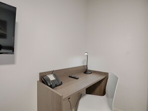 Dedicated workspace within the studio, complete with a desk and chair, offering a comfortable spot for work or planning.