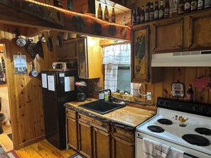 Kitchen, including skillets, pots, pans, toaster, microwave, coffee pot, dishes