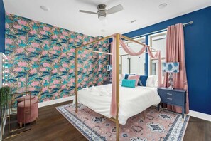 A chic, floral themed bedroom with a gold canopy bed