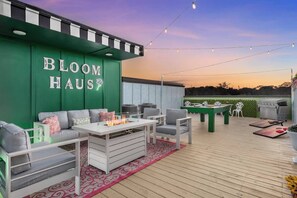 A massive rooftop with plenty of seating for your entire group! Enjoy the pool table and other games, cook up a meal on the griddle, or just relax and enjoy the chic and sophisticated floral vibes before heading out! 