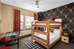 Fun and cozy room with bold deer-print wallpaper, playful decor, and a foosball table for entertainment. Ideal for kids or groups, this space adds a lively twist to your stay with comfort and character.
