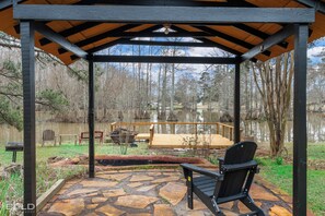 The covered grilling pavilion offers stunning views of the lake, plus a charming little waterfall, making it the perfect spot to cook, dine, and unwind in the great outdoors.