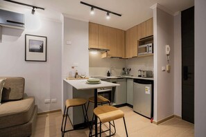 Enjoy a modern kitchen with sleek appliances and cozy bar seating, perfect for cooking and dining in style.