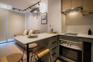 Experience modern living in this stylish kitchen, featuring sleek appliances and cozy seating, perfect for your culinary adventures.