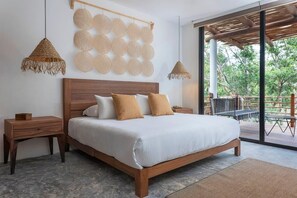 Modern and bohemian room with a spacious king-size bed. It includes a private balcony.