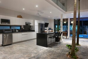 Fantastic fully-equipped kitchen with modern appliances. Natural trees in the center complete the space.