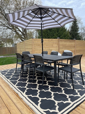 brand new outdoor dining table & chairs. Umbrella has LED lights