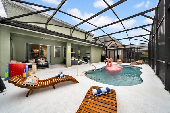 Swimming pool with sun loungers and inflatables