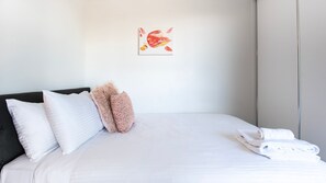 The bedroom features a comfortable queen-sized bed, perfect for a restful night's sleep.