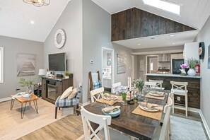 Table with seating for six along with breakfast bar area.