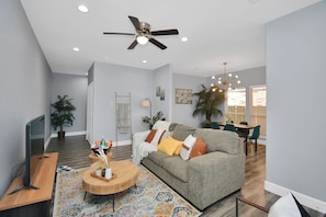 Unwind in the inviting living room, where a plush, cozy couch awaits your perfect moment of relaxation.