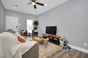 Living room with comfortable sleeper bed and smart TV