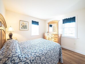 Spacious bedroom with a queen-sized bed and plenty of natural light for a cozy, relaxing retreat.