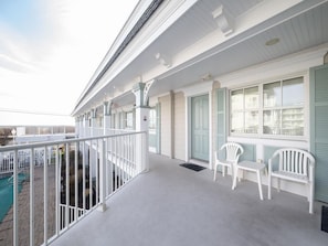 Exterior walkway with seating, offering a peaceful spot to relax and take in the fresh ocean air.