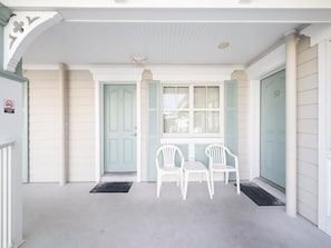 Cozy covered patio with seating, perfect for enjoying your morning coffee or unwinding after a day at the beach.