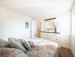 Spacious and serene bedroom with soft bedding, ideal for a restful night's sleep.