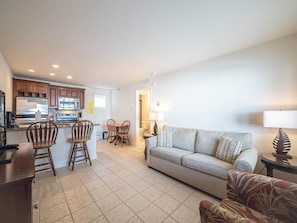 Bright and inviting living room with a queen sleeper sofa, perfect for unwinding after a beach day.