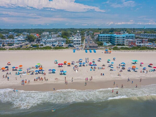 Stunning beachfront with golden sand and vibrant beachgoers—enjoy the best of Cape May right outside your door.