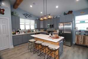 Open kitchen. All stainless-steel appliances with dishwasher.