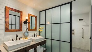 Vista Encantada bath with dual sinks, walk-in shower, and frosted glass.