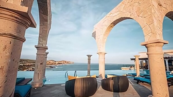 Vista Encantada infinity pool with arches and panoramic sea views.