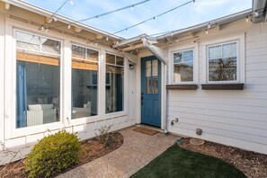 Front entry and courtyard with string lights.