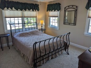 upstairs bedroom with queen  and access to shared bath