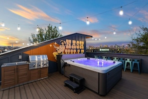 Enjoy the Nashville skyline from this beautiful rooftop oasis featuring a hot tub and grilling area, perfect for large groups, bachelorette parties, or family reunions in Music City.