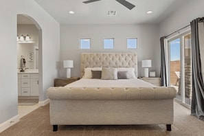 Main-level master suite with king bed, sofa bed, and private ensuite bath