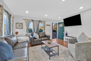 Spacious living room with queen-size sofa bed and Xbox entertainment