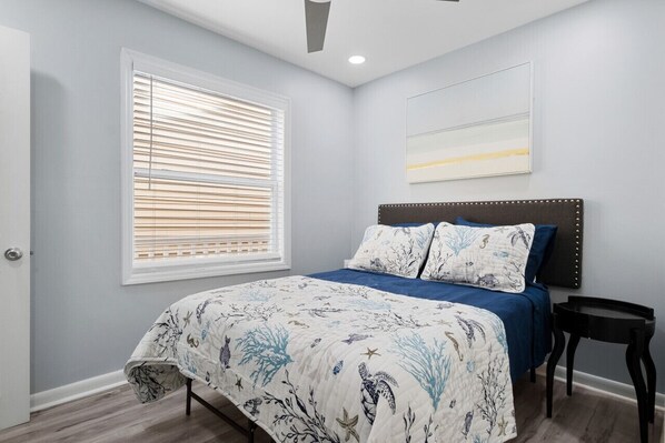 Bright and inviting, this charming bedroom features coastal-inspired bedding.
