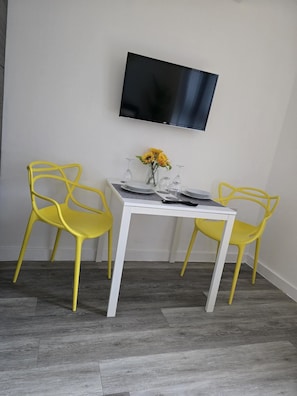 Dining area with ample amounts of plates, bowls and cutlery.