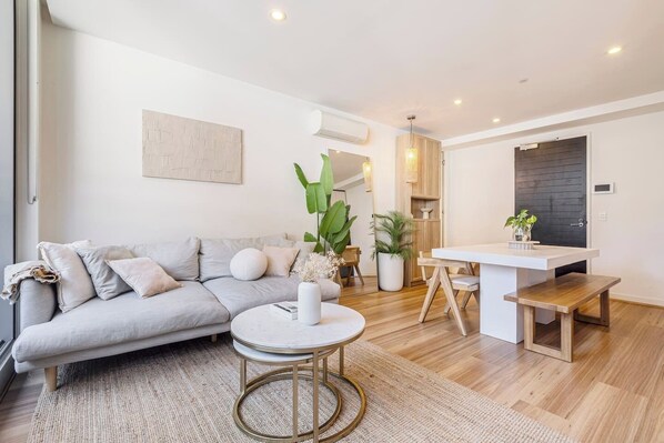 A cosy living area encourages movie nights at home with a sofa and split-system heating and cooling.
