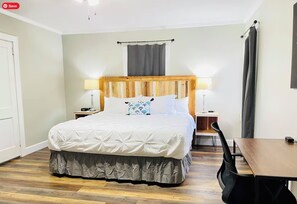 Master bedroom w/ king bed, full bath,  walk-in closet, office desk, & Smart TV.