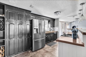 "Indoors","Floor","Kitchen","Refrigerator","Lamp"