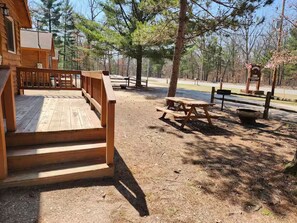 Outdoor space, each cabin has a picnic table, firepit, and charcoal grill.