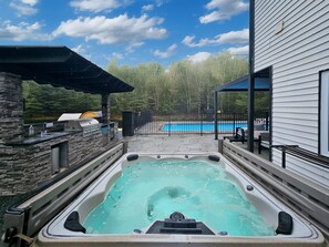 Luxury hot tub with pool views.
